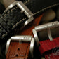 Three watch straps with contrasting styles: black checkered leather, brown alligator grain, and red textured leather, each showcasing a polished metal "AP Bands" buckle. 
